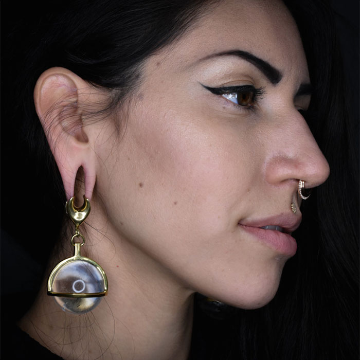 Black Hole Body Piercing client displays ear and septum piercings