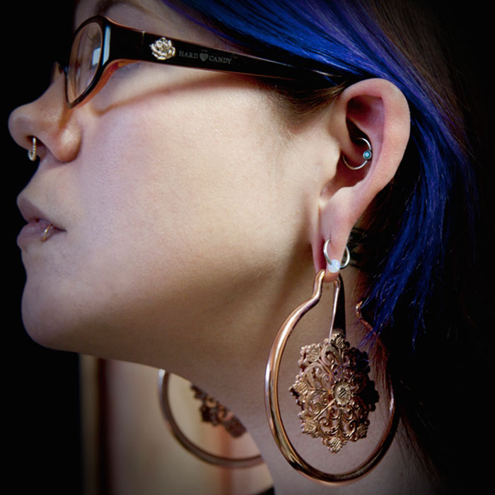 Black Hole Body Piercing client displaying ear and septum piercings