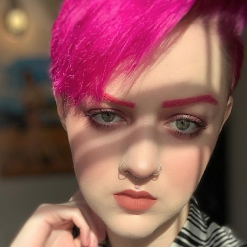 Girl with pink hair displays nose piercings